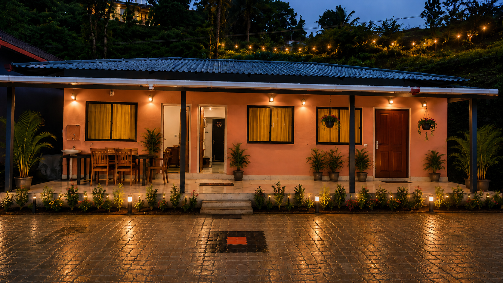 Mungaru Woods Homestay exterior at night with warm lights